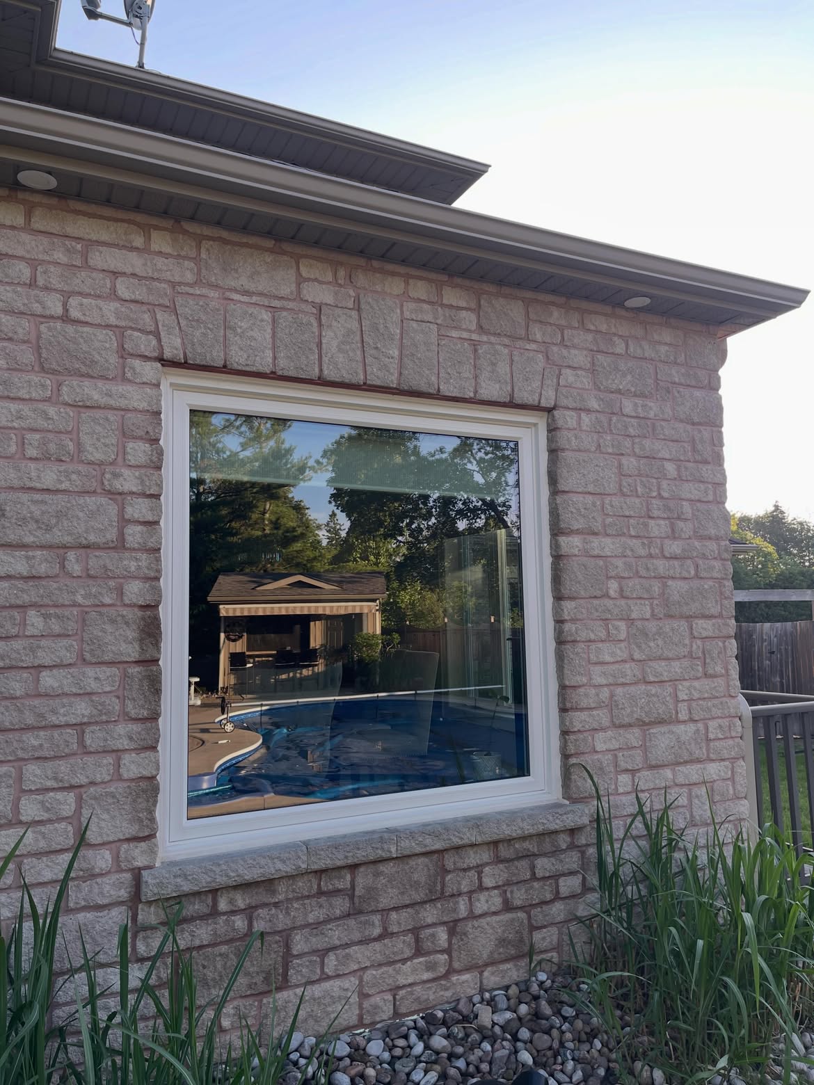 Shine Works technician window cleaning a home in Barrie, Ontario